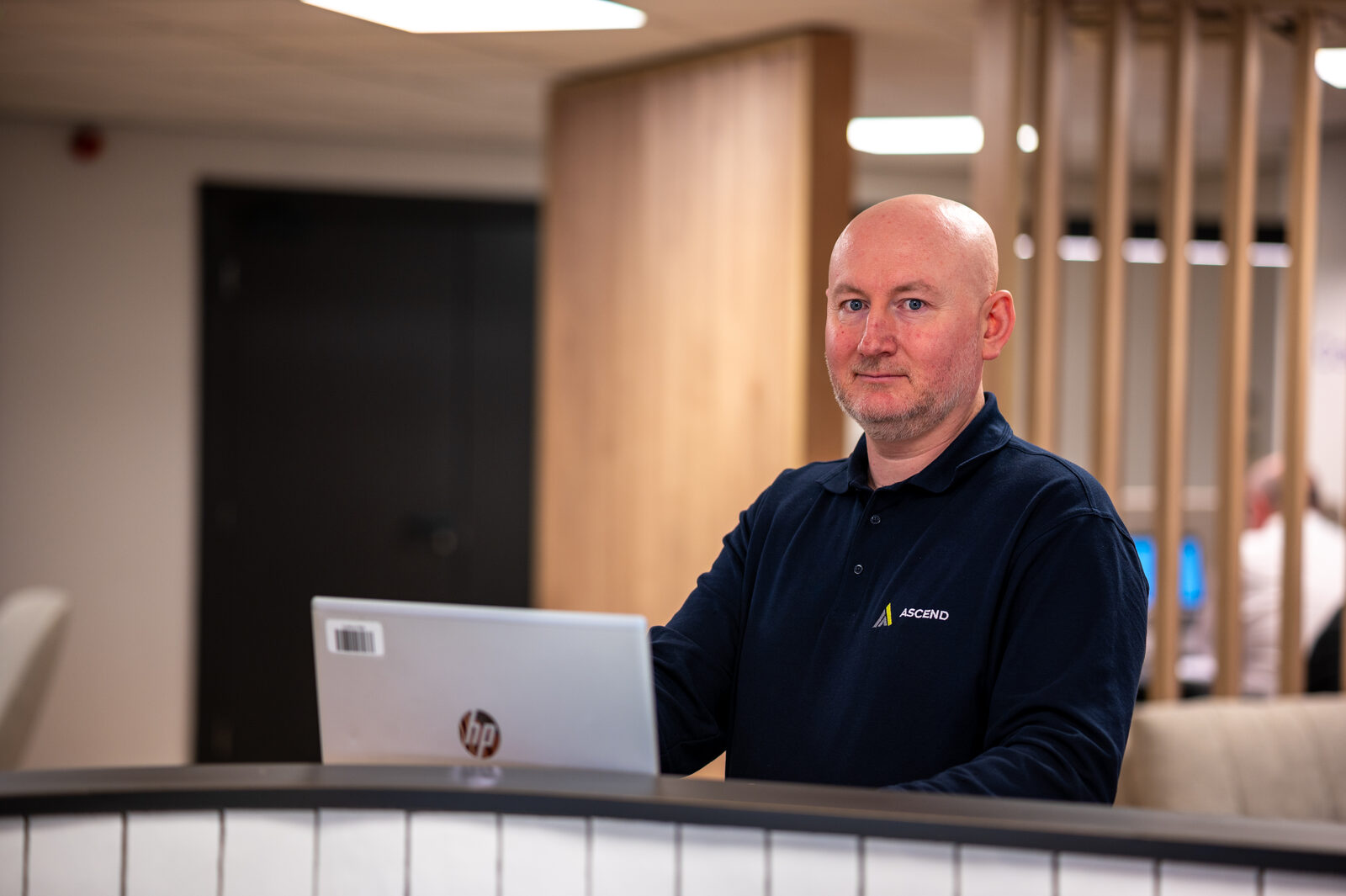 James Wooton working at a reception desk