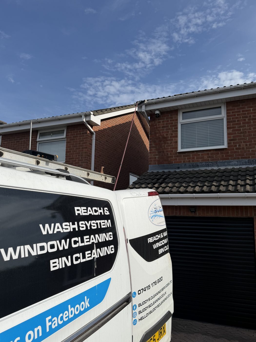 Buddy&rsquo;s van with reach-and-wash system at a house