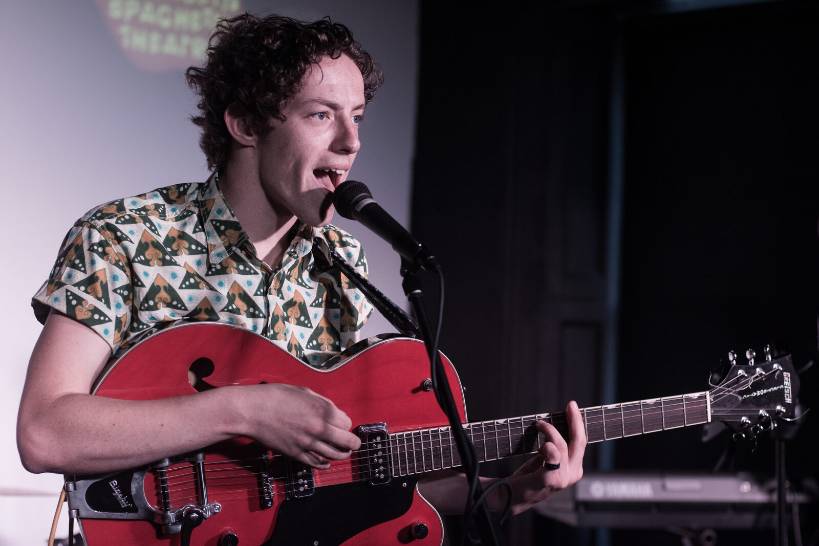 Charlie Dancer playing a red guitar live