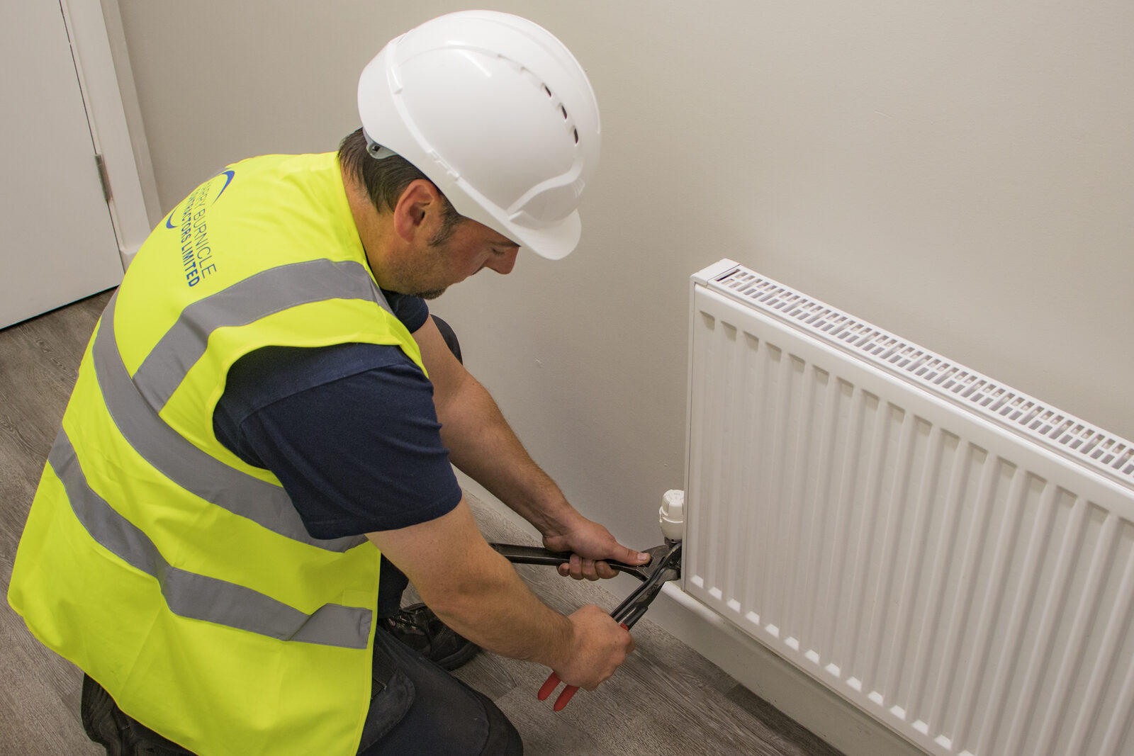 Harry Burnicle heating engineer working on a boiler
