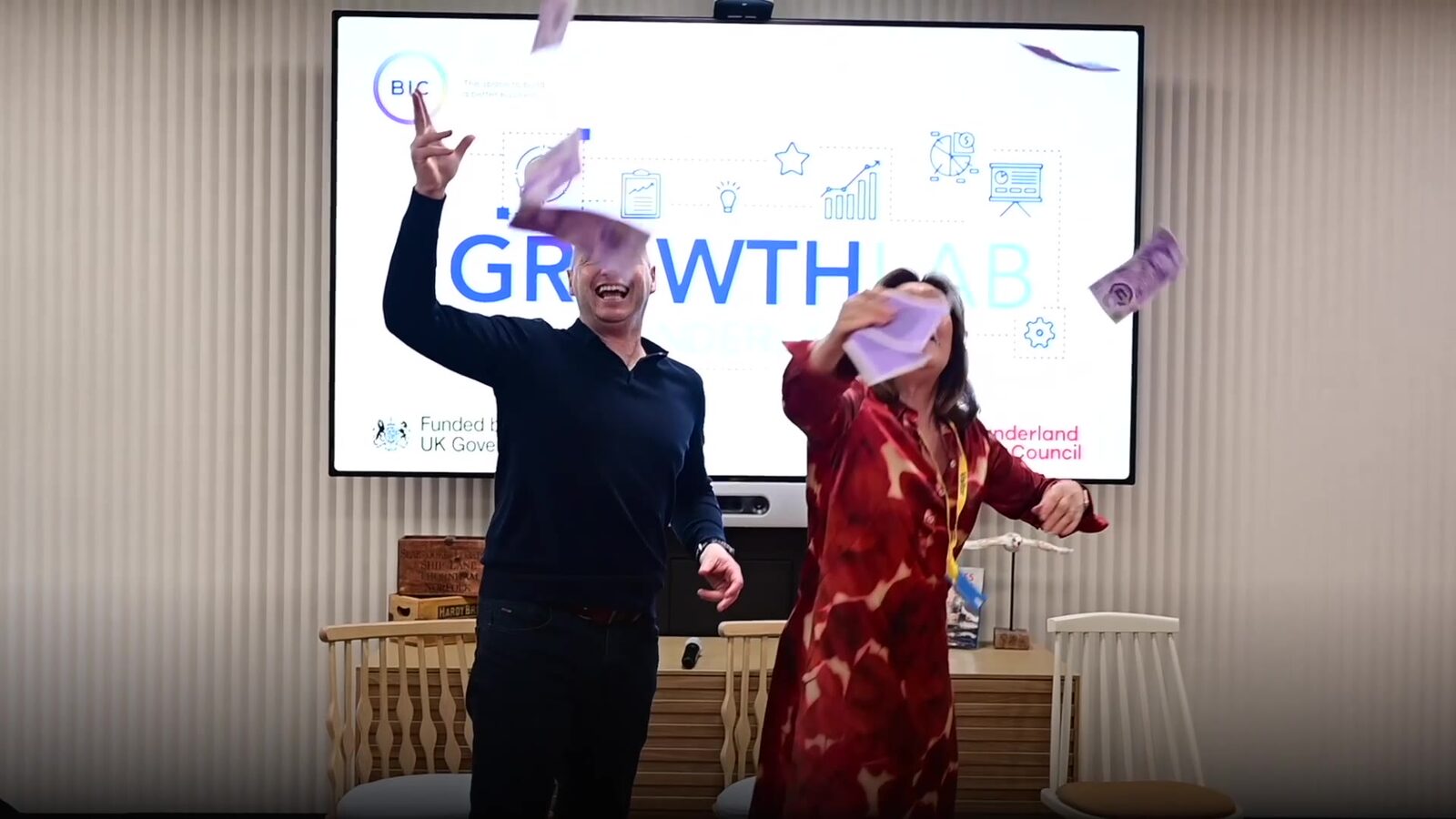 Speakers on stage in front of the Growth Lab screen