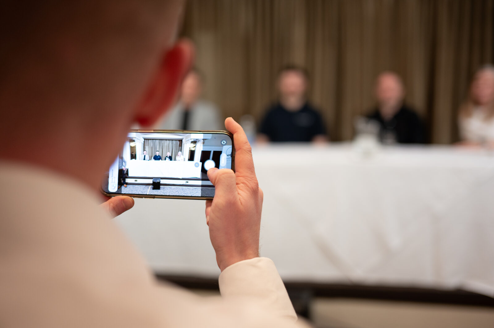 Guest filming the panel on a phone