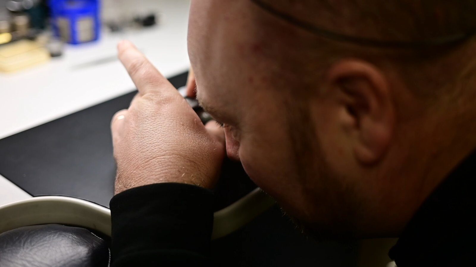 Close-up of watch repair with tweezers