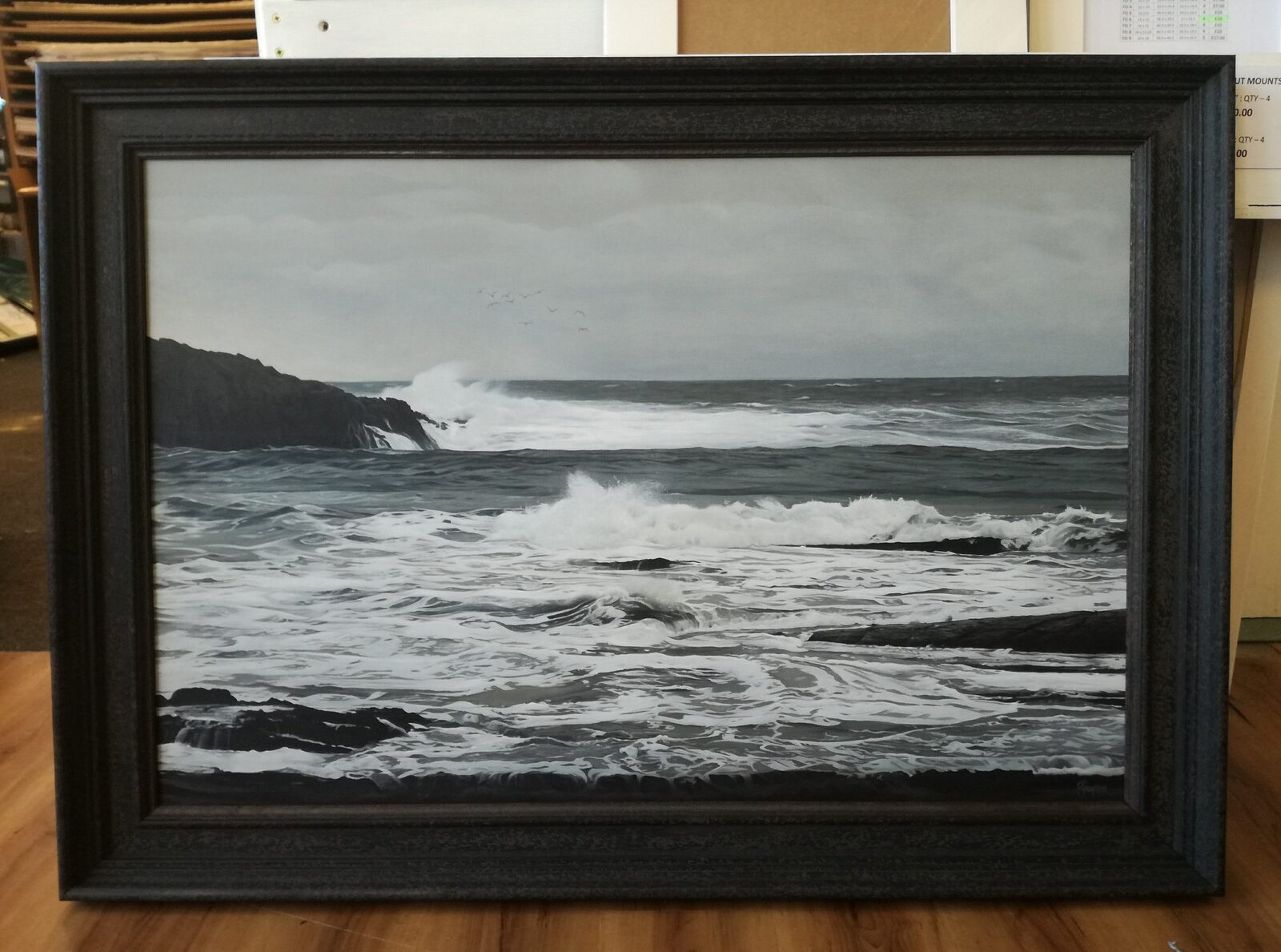 Seascape painting in a dark wooden frame