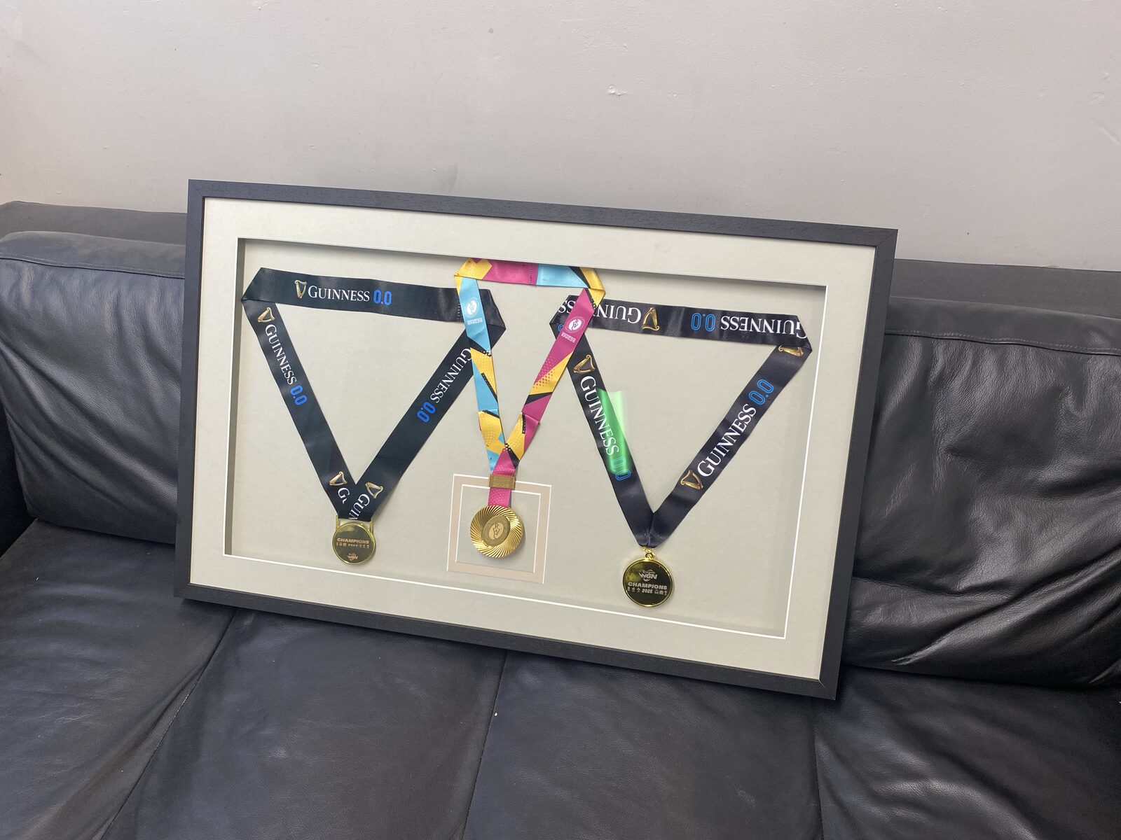 Three medals box-framed with their ribbons